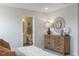 Bedroom featuring a dresser with a decorative mirror and view of the adjacent bathroom at 195 Anise Ln, Garner, NC 27529
