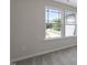 Bedroom with neutral carpet, light gray walls, and large windows offering an outdoor view at 195 Anise Ln, Garner, NC 27529