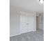 Neutral bedroom features double-door closet, gray carpet, and attached bathroom access at 195 Anise Ln, Garner, NC 27529