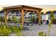 Community outdoor space featuring a pergola, fireplace, picnic tables and Adirondack chairs at 195 Anise Ln, Garner, NC 27529
