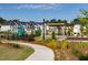 View of the community park featuring a playground and picnic tables surrounded by lush landscaping at 195 Anise Ln, Garner, NC 27529
