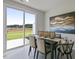 Elegant dining room with sliding glass doors to patio and stylish decor on the dining table with seating for six at 195 Anise Ln, Garner, NC 27529