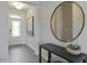 Bright entryway featuring wood-look floors, a white door with glass, and a round mirror above a dark console table at 195 Anise Ln, Garner, NC 27529
