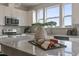 Bright kitchen showcases granite counters, stainless steel appliances, white cabinetry, and large sink window at 195 Anise Ln, Garner, NC 27529