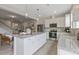 Open kitchen featuring a large center island with seating, white cabinetry, and stainless steel appliances at 195 Anise Ln, Garner, NC 27529