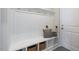 Functional mudroom area with coat hooks, bench seating with storage, and decorative pillows at 195 Anise Ln, Garner, NC 27529