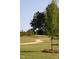 A serene walking path winds through a community park with manicured lawn and mature trees at 195 Anise Ln, Garner, NC 27529