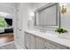 Bright bathroom featuring a large mirror, modern vanity with quartz countertop, and stylish fixtures at 620 Wade Ave # 301, Raleigh, NC 27605