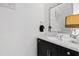 Stylish bathroom vanity featuring a marble countertop, decorative mirror, and modern fixtures at 620 Wade Ave # 301, Raleigh, NC 27605