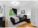 Cozy bedroom with hardwood floors, large window, and stylish furnishings at 620 Wade Ave # 301, Raleigh, NC 27605
