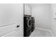 Modern laundry room featuring sleek front-load washer and dryer units with overhead cabinets at 620 Wade Ave # 301, Raleigh, NC 27605