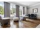 Bright living area with hardwood floors, large windows, and a dining area with modern furnishings at 620 Wade Ave # 301, Raleigh, NC 27605
