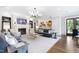 Sophisticated living room with a fireplace, chandelier, modern art, and comfortable seating arrangements at 620 Wade Ave # 301, Raleigh, NC 27605