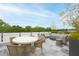 Stylish rooftop deck featuring a dining area, fire pit, comfortable seating, and scenic treetop views at 620 Wade Ave # 301, Raleigh, NC 27605
