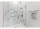 Modern glass-enclosed shower with marble tile and rainfall showerhead for a luxurious bathing experience at 620 Wade Ave # 301, Raleigh, NC 27605