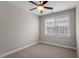 Bedroom with neutral walls, carpet, ceiling fan, and a bright window at 836 Bankston Woods Way, Raleigh, NC 27609