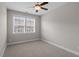 Bedroom featuring neutral walls, carpet, ceiling fan, and a bright window at 836 Bankston Woods Way, Raleigh, NC 27609