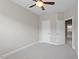 Bedroom featuring neutral walls, carpet, ceiling fan, and two doors at 836 Bankston Woods Way, Raleigh, NC 27609