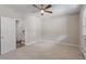 Bonus room with ceiling fan, carpet, access to hallway and out to the backyard at 836 Bankston Woods Way, Raleigh, NC 27609