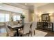 Elegant dining room with modern light fixture and a seamless view of the kitchen at 836 Bankston Woods Way, Raleigh, NC 27609