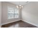 This spacious dining area features a modern chandelier and a large window with natural light at 836 Bankston Woods Way, Raleigh, NC 27609