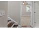 Hallway with hardwood stairs leading to a room with carpet, fan, and natural light at 836 Bankston Woods Way, Raleigh, NC 27609