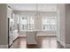 Bright kitchen features a large center island with light countertops and modern stainless steel appliances and ample natural light at 836 Bankston Woods Way, Raleigh, NC 27609