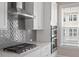 The kitchen features stainless steel appliances, a gray backsplash, lots of countertop space, and natural light at 836 Bankston Woods Way, Raleigh, NC 27609