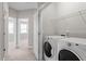 Laundry room featuring white washer and dryer and a wire rack for storage at 836 Bankston Woods Way, Raleigh, NC 27609