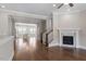 Bright and spacious living room with hardwood floors and an adjacent kitchen area at 836 Bankston Woods Way, Raleigh, NC 27609
