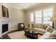 Warm living room featuring a fireplace, light-colored walls and modern furniture at 836 Bankston Woods Way, Raleigh, NC 27609