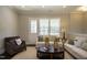 Cozy living room with neutral walls, modern furniture, and natural light from the patio door at 836 Bankston Woods Way, Raleigh, NC 27609