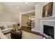 Cozy living room with fireplace and hardwood floors; dining area visible at 836 Bankston Woods Way, Raleigh, NC 27609