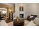 Bright living room with stairs adjacent to the fireplace and kitchen nearby at 836 Bankston Woods Way, Raleigh, NC 27609