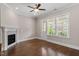 Open living room with hardwood flooring, fireplace, and a door to the balcony at 836 Bankston Woods Way, Raleigh, NC 27609