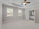 Spacious main bedroom with tray ceiling, ceiling fan, and ensuite bathroom entrance at 836 Bankston Woods Way, Raleigh, NC 27609