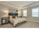 Comfortable bedroom boasts neutral color scheme, carpet floors, and stylish decorations at 836 Bankston Woods Way, Raleigh, NC 27609