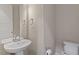Powder room with pedestal sink, toilet, and light neutral paint at 836 Bankston Woods Way, Raleigh, NC 27609