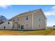 The backyard view of a two-story house with sliding glass doors and neutral vinyl siding at 2820 Lacy Holt Rd, Graham, NC 27253
