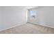 Inviting bedroom featuring plush carpeting, a window overlooking the neighborhood and a closet door at 2820 Lacy Holt Rd, Graham, NC 27253