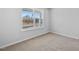 Bright bedroom features plush carpet and a window with views of neighborhood homes under construction at 2820 Lacy Holt Rd, Graham, NC 27253