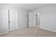 Comfortable bedroom with neutral walls, plush carpet, and doors leading to other rooms at 2820 Lacy Holt Rd, Graham, NC 27253
