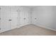 Spacious bedroom with carpeted floor, multiple closets, and doors, providing plenty of storage at 2820 Lacy Holt Rd, Graham, NC 27253