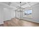 Bright dining room boasts elegant coffered ceilings, hardwood floors, and ample natural light at 2820 Lacy Holt Rd, Graham, NC 27253