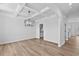 Well-lit dining area showcasing coffered ceilings, wood floors, and a modern chandelier at 2820 Lacy Holt Rd, Graham, NC 27253