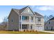 Inviting two-story house with a front porch and a two-car garage, set on a well-maintained lawn at 2820 Lacy Holt Rd, Graham, NC 27253