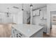 Open-concept kitchen featuring a center island, stylish pendant lighting, and ample cabinet space at 2820 Lacy Holt Rd, Graham, NC 27253