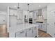 Bright kitchen with a center island, modern appliances, light cabinetry and wooden floors at 2820 Lacy Holt Rd, Graham, NC 27253