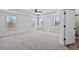 Expansive main bedroom featuring tray ceilings, carpet flooring and lots of natural light from the many windows at 2820 Lacy Holt Rd, Graham, NC 27253