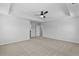 Spacious main bedroom featuring carpet floors, tray ceiling, a ceiling fan and large windows at 2820 Lacy Holt Rd, Graham, NC 27253